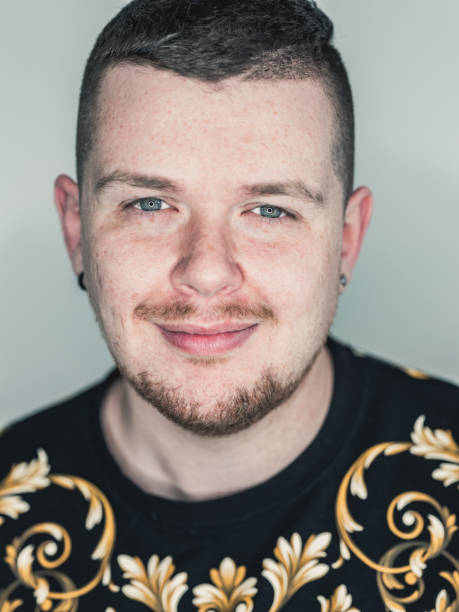 Portrait of Caucasian LGBTQ male against monochrome backdrop stock photo