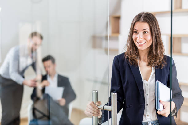 Portrait of cheerful modern female professional in modern office stock photo
