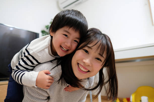 Portrait of child and mother Portrait mother and son in house east asian ethnicity stock pictures, royalty-free photos & images