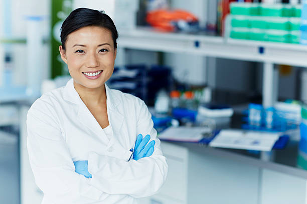 Portrait of confident female scientist Portrait of confident female scientist in modern laboratory biotechnology stock pictures, royalty-free photos & images