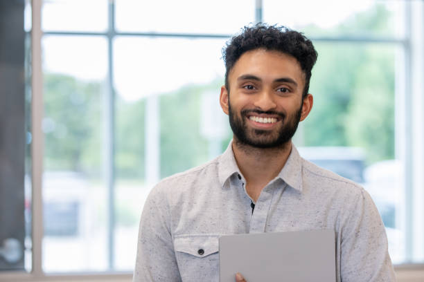Portrait of Confident Young professional smiling at camera stock photo