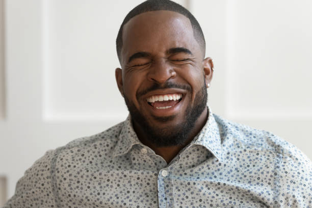 Close up portrait of excited african American man in good mood...