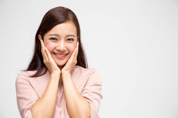 Portrait of excited screaming young asian woman standing in pink dress isolated over white background, Wow and surprised concept  tickling beautiful women pictures stock pictures, royalty-free photos & images