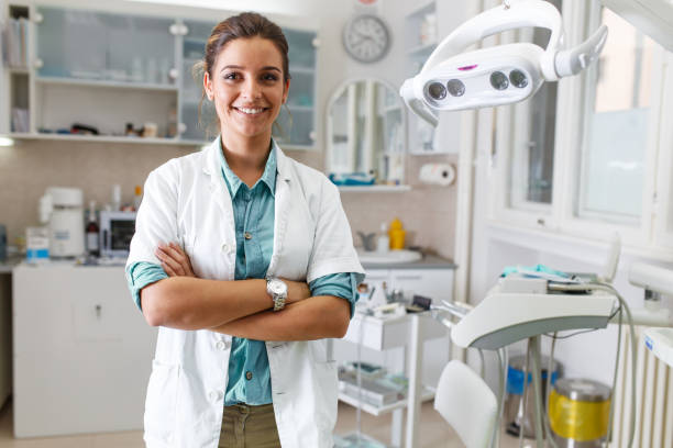 Portrait of female dentist . Portrait of female dentist .She standing in her dentist office.. orthodontist stock pictures, royalty-free photos & images