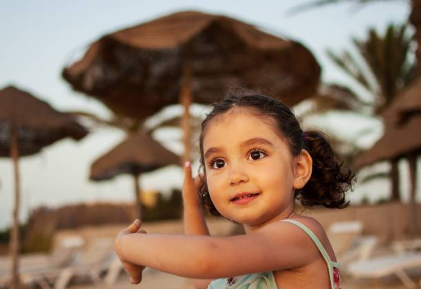 Portrait of girl. A child playing on the beach. tunisian girls stock pictures, royalty-free photos & images