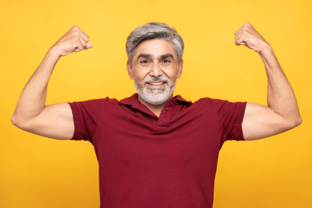 portrait of handsome mature man isolated over yellow background:- stock photo  healthy stock pictures, royalty-free photos & images