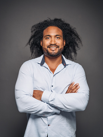 Portrait Of Handsome Mixed Race Man With Curly Hair In Studio