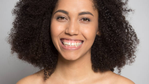 Portrait of happy african American girl with wide smile Close up portrait of positive mixed race ethnicity young woman isolated on grey studio background show good work after dentist treatment, smiling african American girl demonstrate white healthy teeth my nude webcam stock pictures, royalty-free photos & images