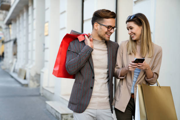 Portrait of happy couple with shopping bags. People sale consumerism and lifestyle concept. stock photo