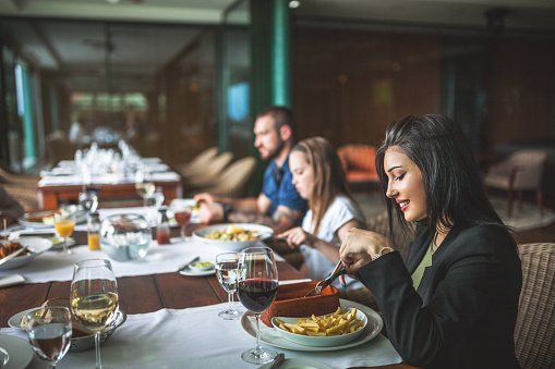 Portrait Of Happy Family Eating In The Restaurant Stock Photo