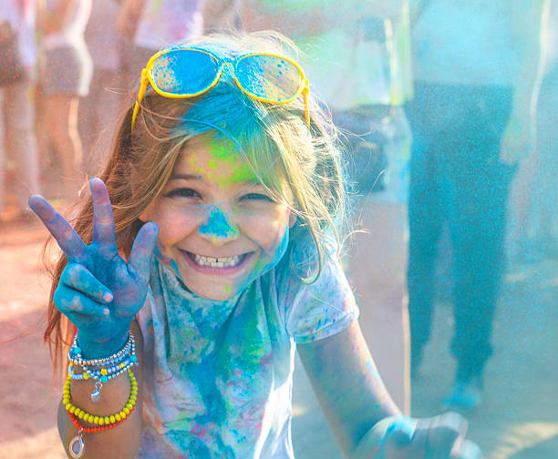 Portrait of happy litttle girl on holi color festival stock photo