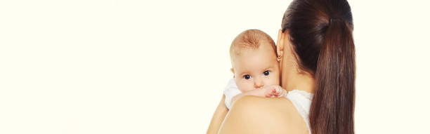 Portrait of happy mother holding cute baby on white background, blank copy space for advertising text stock photo