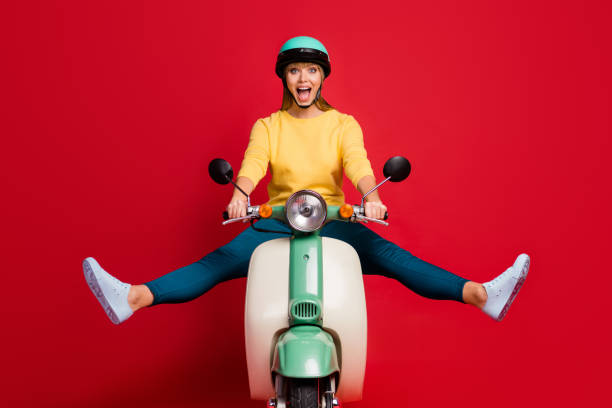 Portrait of her she nice attractive lovely funny glad cheerful cheery girl driving moped traveling having fun fooling isolated on bright vivid shine vibrant red color background Portrait of her she nice attractive lovely funny glad cheerful cheery girl driving, moped traveling having fun fooling isolated on bright vivid shine vibrant red color background motor scooter stock pictures, royalty-free photos & images