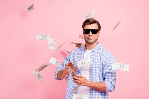 Portrait of his he nice cool trendy content attractive handsome candid guy wearing checked shirt throwing money flying in air party wealth isolated over pink pastel background  throwing stock pictures, royalty-free photos & images