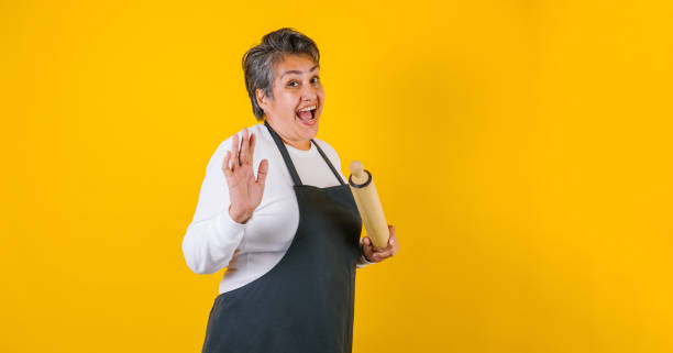 Portrait of hispanic woman middle aged cooking and holding mexican mortar with sauce ingredients in Mexico Latin America stock photo