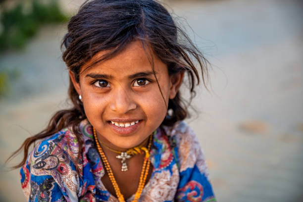 Portrait of Indian little girl in desert village, India stock photo