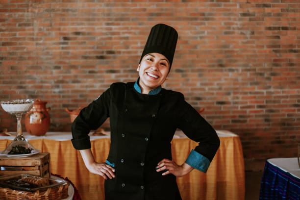 Portrait of latin female chef smiling in mexican restaurant stock photo