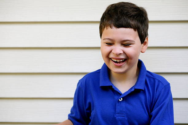 Portrait of laughing boy with autism stock photo