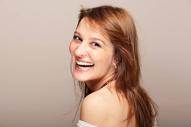 Portrait of laughing redhead woman turning around stock photo