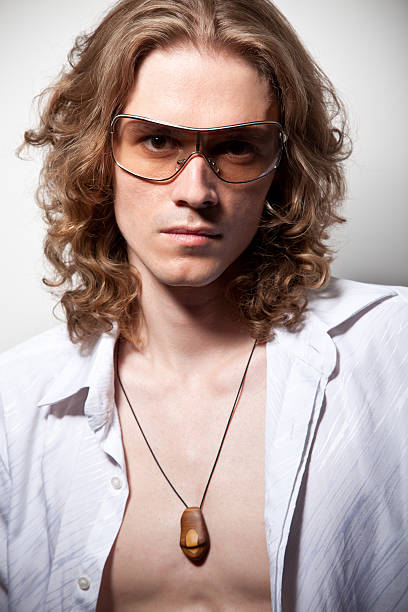 Portrait of long-haired handsome man in sunglasses stock photo