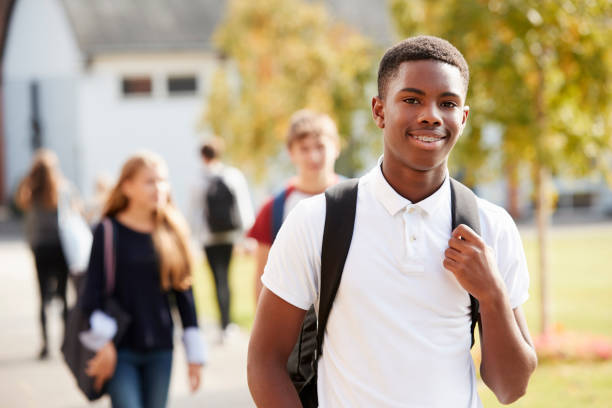 Portrait Of Male Teenage Student Walking Around College Campus Portrait Of Male Teenage Student Walking Around College Campus 14 15 years stock pictures, royalty-free photos & images
