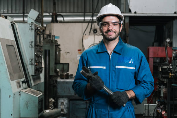portrait of man engineering standing at factory with holding big wrench tool and looking at camera. portrait of man engineering standing at factory with holding big wrench tool and looking at camera. engineering student stock pictures, royalty-free photos & images
