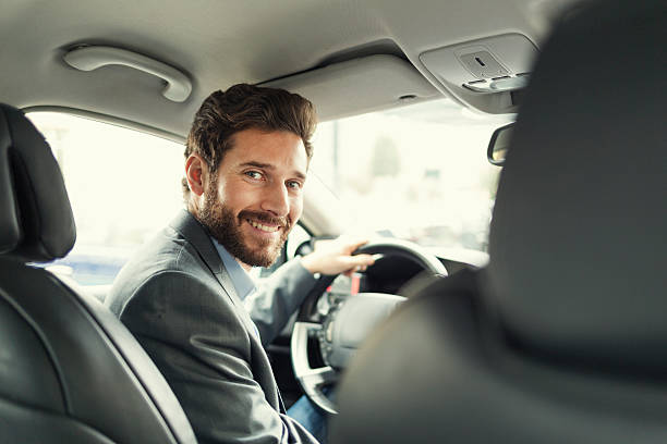 Portrait of man in his car. looking camera stock photo