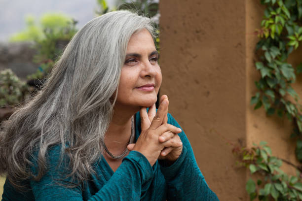 Portrait of middle aged woman with long gray hair stock photo