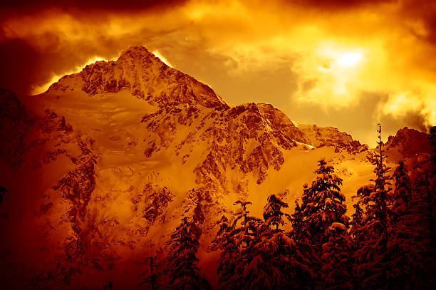 Portrait of Mountains and Forest Covered in Snow, Red Toned stock photo