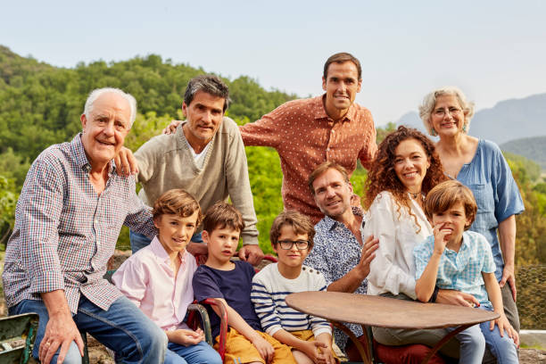 Portrait of multi generation family in yard Portrait of family resting in yard. Parents and children are wearing casuals. They are spending leisure time together. spain photos stock pictures, royalty-free photos & images