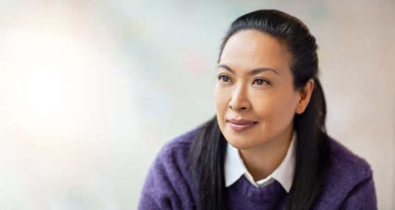 Portrait of multiracial Asian Hispanic Pacific Islander woman in modern office looking away
