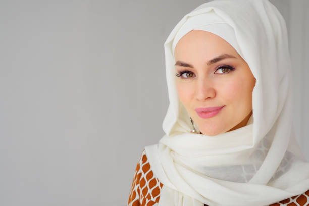Portrait of muslim arabian woman wearing hijab, looking at camera Portrait of beautiful young muslim arabian woman wearing white hijab looking at camera, copy space beautiful arab woman stock pictures, royalty-free photos & images