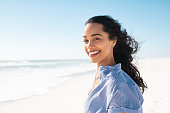 istock Portrait of natural beauty woman at beach 1369509530