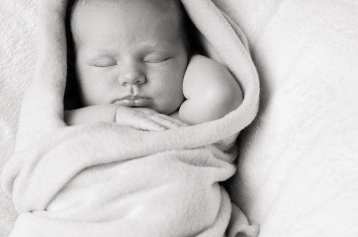 Portrait Of Newborn Baby Swaddled In Blanket And Sleeping ...