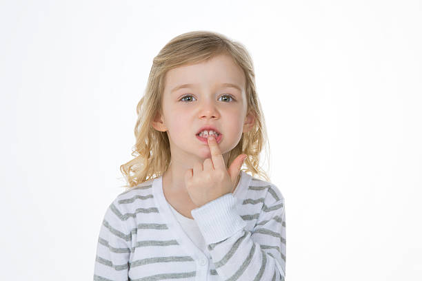 portrait of nice girl on white background worried child proudly showing her baby tooth rotten teeth in children stock pictures, royalty-free photos & images