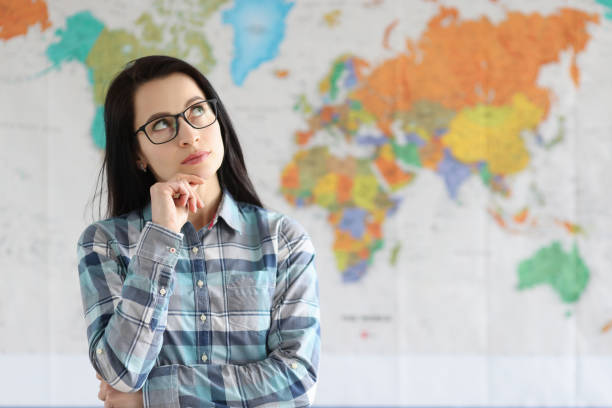 Portrait of pensive woman on background of world map stock photo