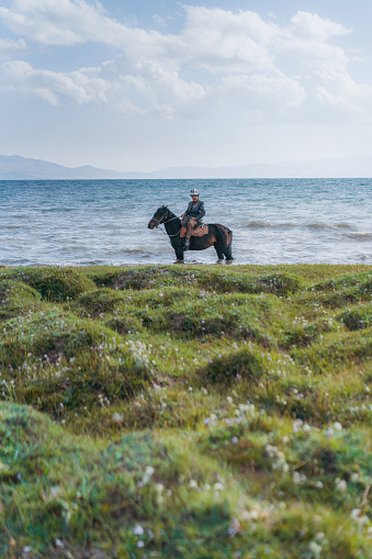 Portrait of senior man on horse near Son-Kul lake, Kyrgyzstan