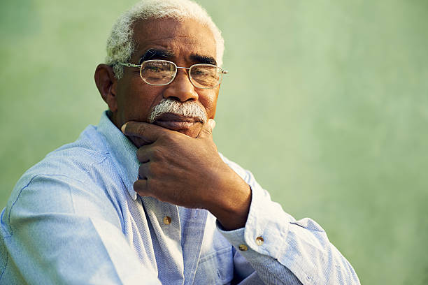 Portrait of serious african american old man looking at camera Black people and emotions, portrait of depressed senior man with glasses looking at camera. Copy space sad old black man stock pictures, royalty-free photos & images