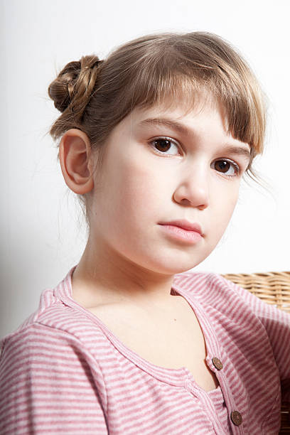 portrait of serious little girl stock photo