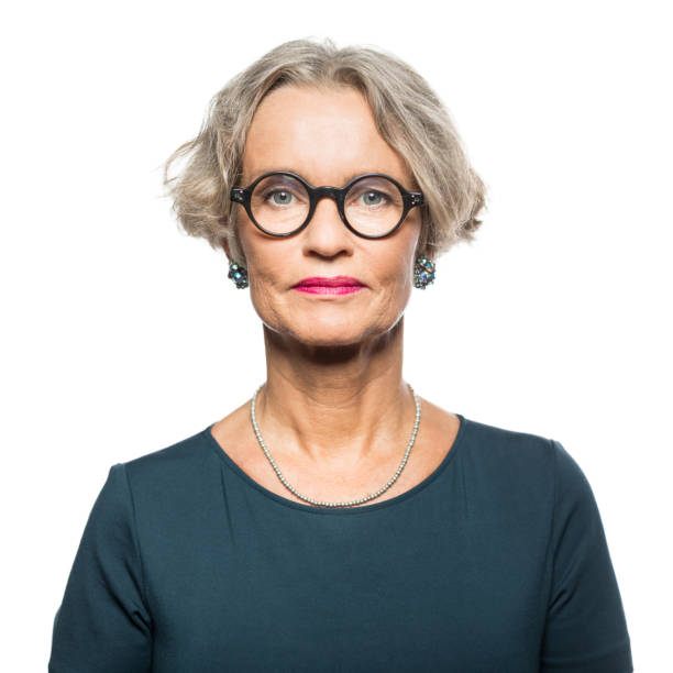 Portrait of serious senior woman Portrait of serious senior woman with glasses against white background blank expression stock pictures, royalty-free photos & images