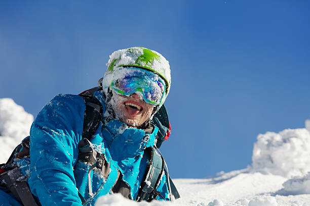 portrait of skier during sunny day - posing with ski stockfoto's en -beelden