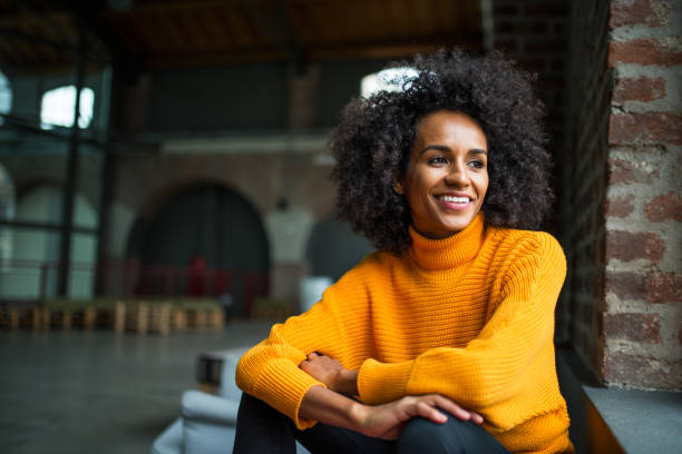 Portrait of smiling African American woman Portrait of smiling African American woman looking trow the window looking away stock pictures, royalty-free photos & images