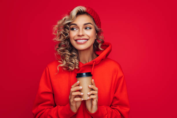 Portrait of smiling girl holding disposable mug of coffee Portrait of smiling girl holding disposable mug of coffee tea hot drink photos stock pictures, royalty-free photos & images