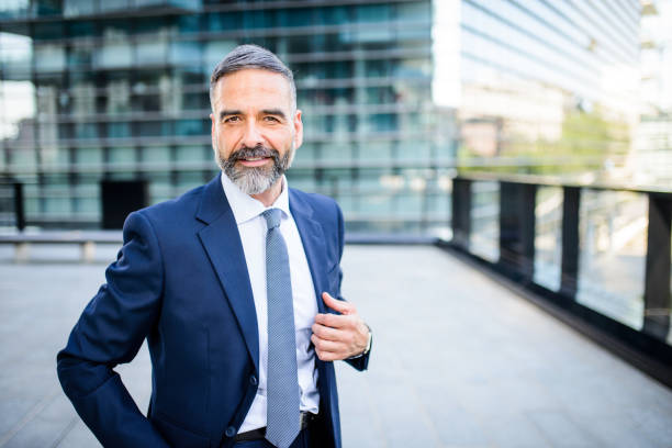 Portrait of smiling mature businessman Portrait of handsome smiling mature businessman looking at the camera 50 59 years photos stock pictures, royalty-free photos & images