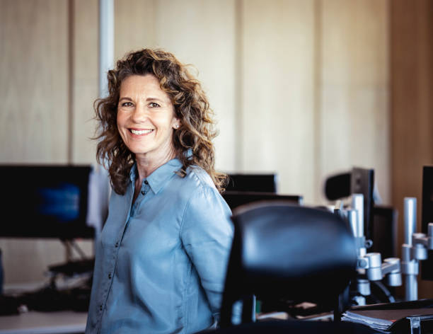 Portrait of smiling mature businesswoman at office stock photo