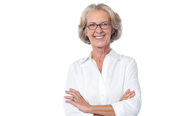 Portrait of smiling old lady, arms crossed. stock photo