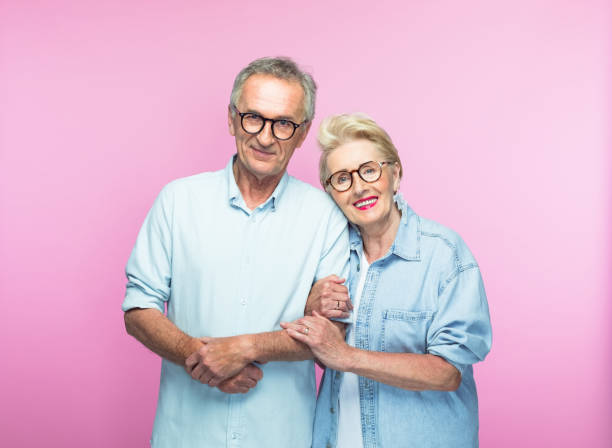 Portrait of smiling senior woman embracing man stock photo