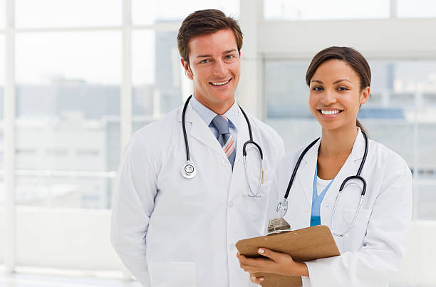Portrait of smiling young doctors stock photo