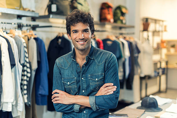 Portrait of successful male owner  with crossed arms in clothing stock photo