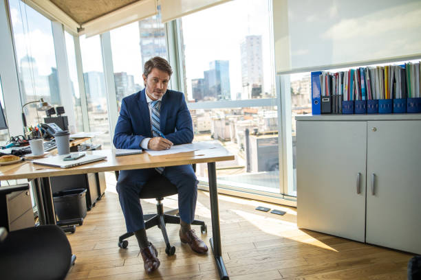 portrait of successful manager in his office - business man shoes on desk imagens e fotografias de stock